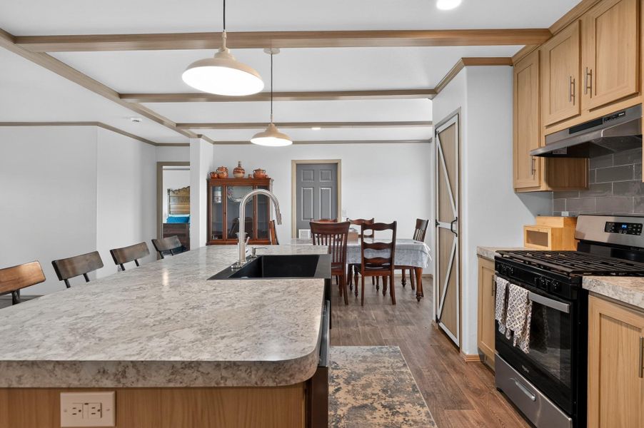 A well-appointed kitchen and dining area provides ample space for daily living and entertaining.