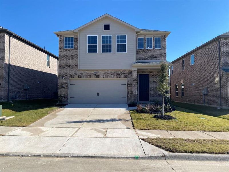 Front of property with a garage and a front lawn