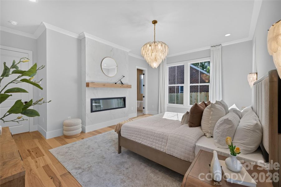 Primary suite boasts fashion-forward Venetian Plaster surround gas fireplace!