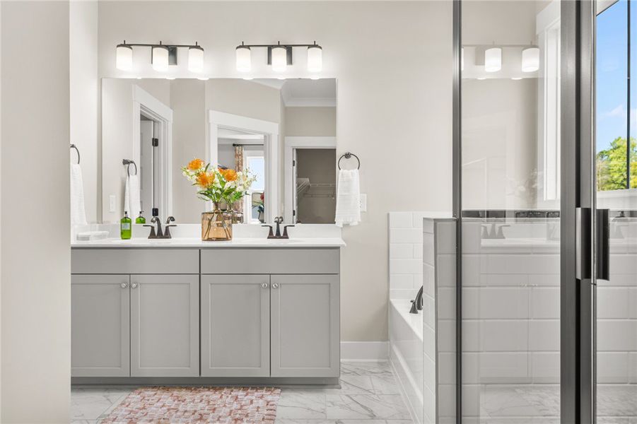 This primary bathroom features a dual vanity, slee
