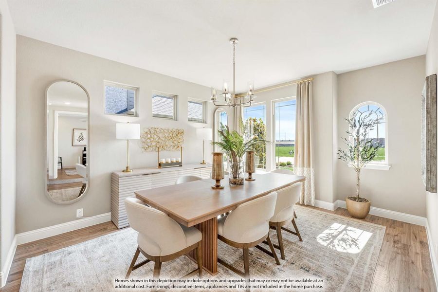 Dining room with wood table, white upholstered chairs, chandelier, and hardwood floors Dining room with wood table, white upholstered chairs, chandelier, and hardwood floors