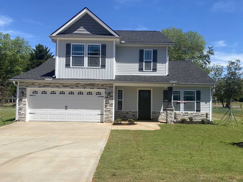Front exterior of a new home in Ballentine Ridge, Lyman, SC, highlighting curb appeal (Image 1). Front exterior of a new home in Ballentine Ridge, Lyman, SC, highlighting curb appeal (Image 1).