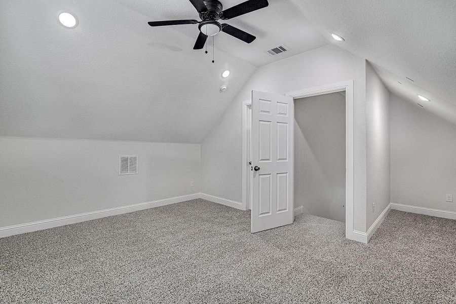 Bedroom 4 or Family Room with ceiling fan, carpet flooring, and vaulted ceiling