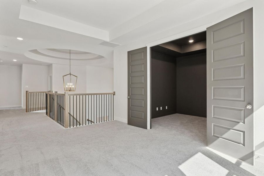 Enjoy a generous second-floor game room, featuring high ceilings with elegant tray details that enhance the sense of space and sophistication. Enjoy a generous second-floor game room, featuring high ceilings with elegant tray details that enhance the sense of space and sophistication.