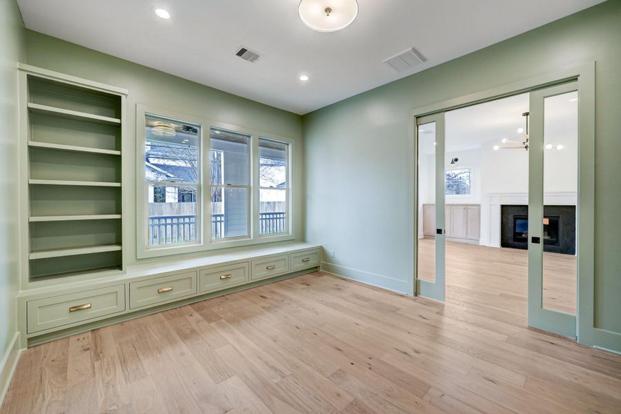 The flex space situated off the living room could be used as a study, playroom or secondary office space. This space overlooks the back porch and features built in bookcases and storage. *Previous Project*