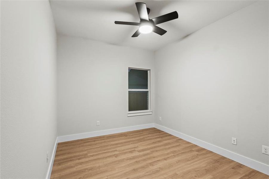 Spare room with ceiling fan and light hardwood / wood-style floors