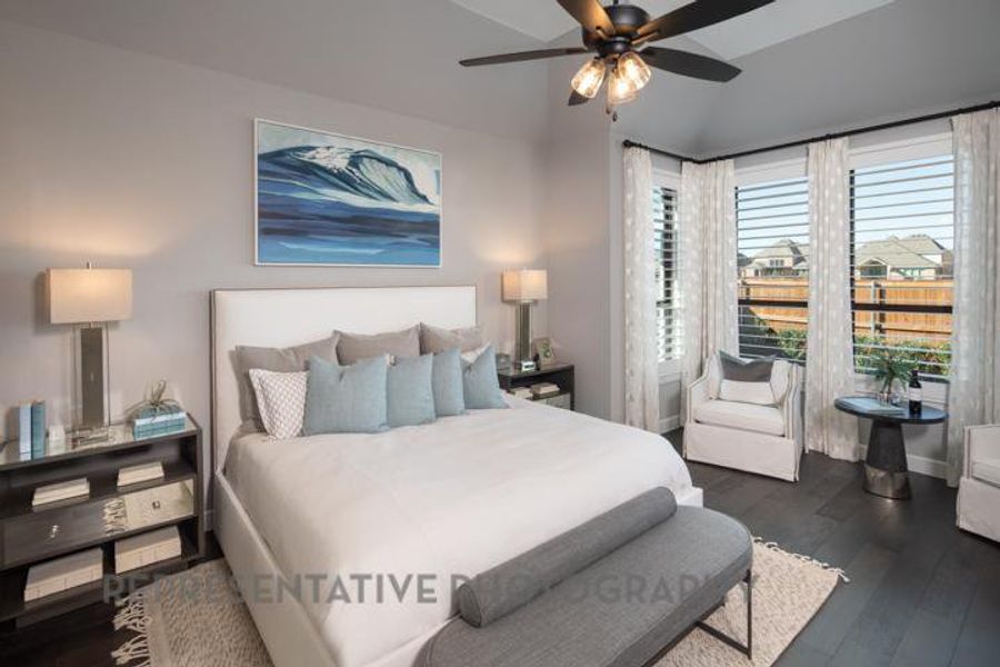 Bedroom with dark wood finished floors, vaulted ceiling, and ceiling fan Bedroom with dark wood finished floors, vaulted ceiling, and ceiling fan
