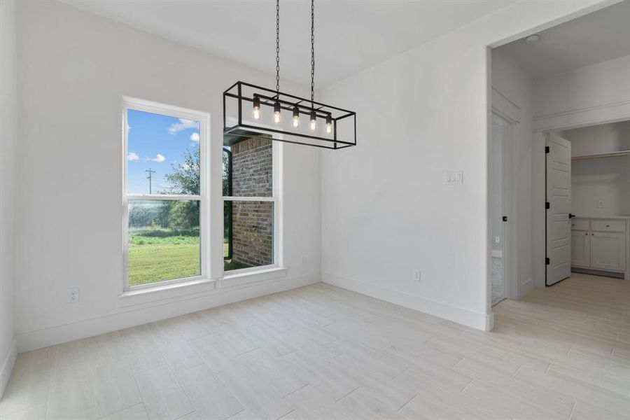 Carpeted empty room with a tray ceiling, ceiling fan, healthy amount of natural light, and ornamental molding