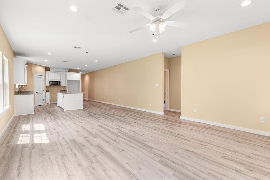 Unfurnished living room featuring recessed lighting, light wood-style floors, and a ceiling fan