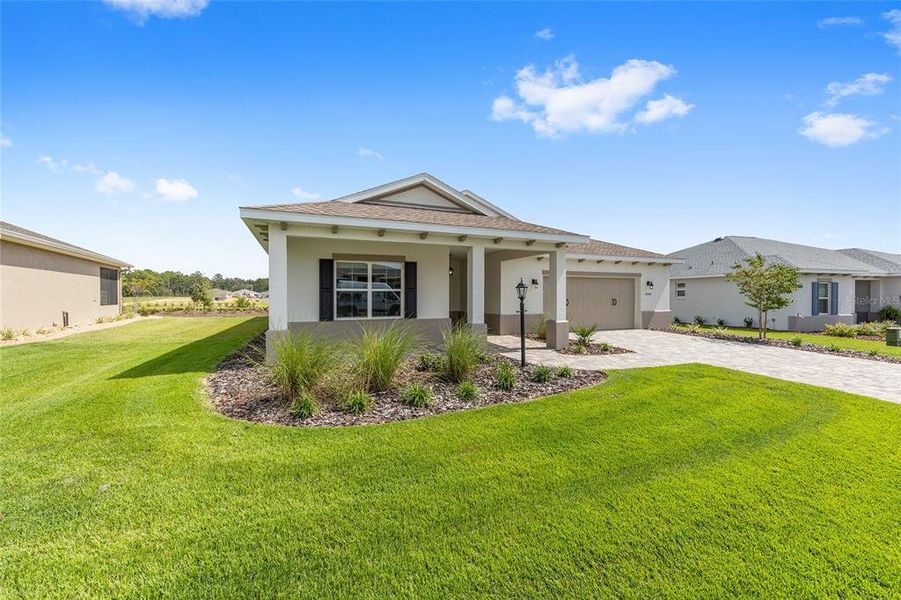 Front exterior of a new home in On Top of the World Communities, Ocala, FL, highlighting curb appeal (Image 1). Front exterior of a new home in On Top of the World Communities, Ocala, FL, highlighting curb appeal (Image 1).