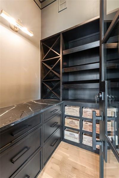 Wine room with light hardwood / wood-style floors