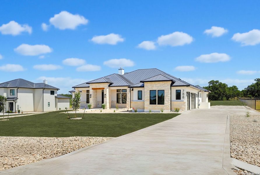 Front exterior of a new home in , Bulverde, TX, highlighting curb appeal (Image 26).