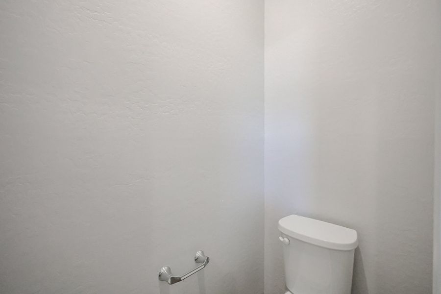 A toilet in a bathroom.