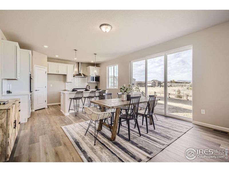Dining area to kitchen *Photo not of actual home, but same floorplan and style*