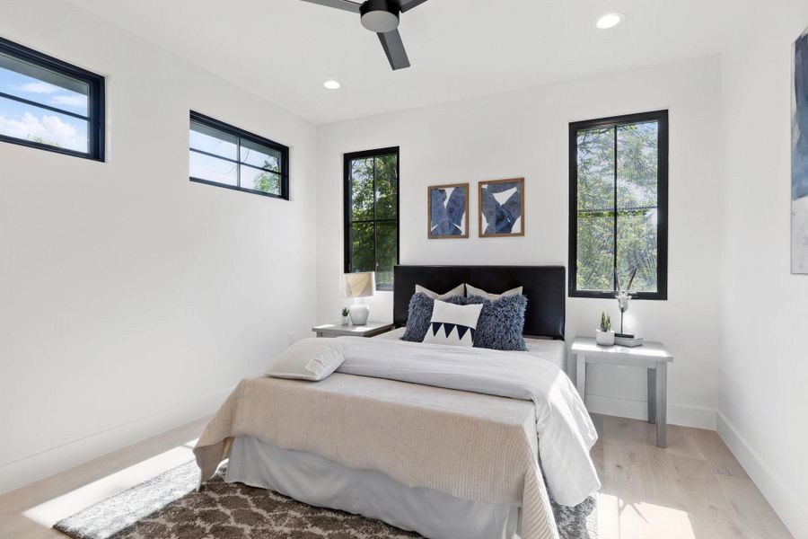 Bedroom with wood finished floors, recessed lighting, and a ceiling fan