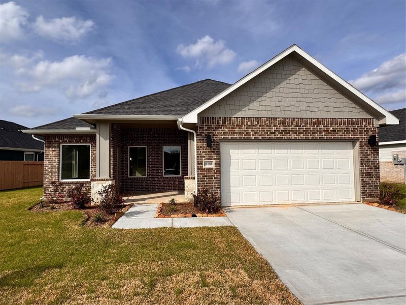 Front exterior of a new home in Grand Oaks Reserve, Cleveland, TX, highlighting curb appeal (Image 2). Front exterior of a new home in Grand Oaks Reserve, Cleveland, TX, highlighting curb appeal (Image 2).