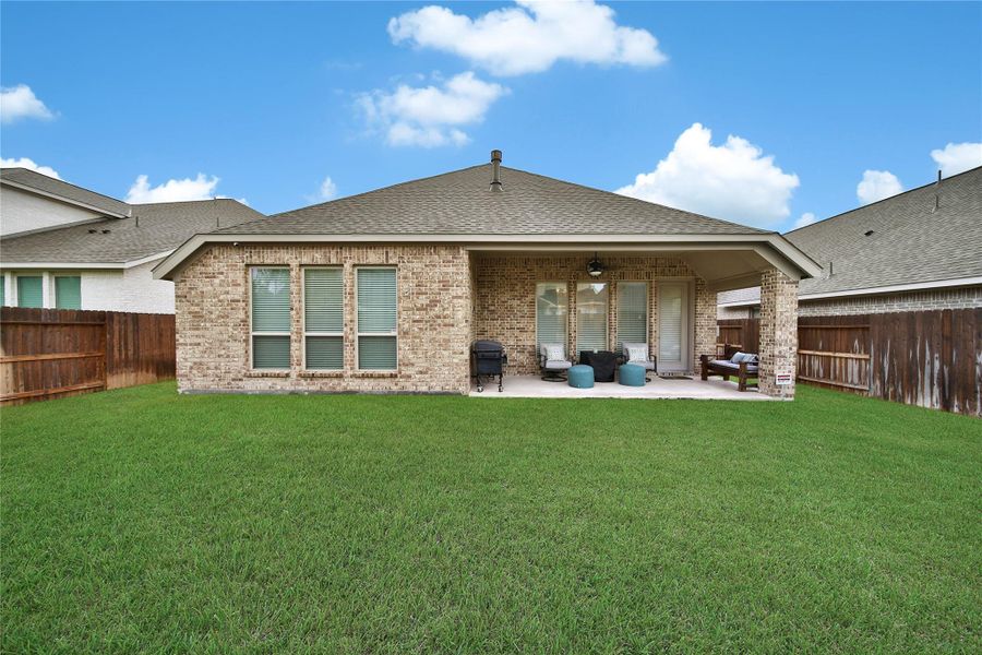 This fenced backyard creates a comfortable outdoor retreat with plenty of room for kids and pets!
