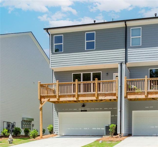 Front exterior of a new home in Hillcrest Landing, Sugar Hill, GA, highlighting curb appeal (Image 26). Front exterior of a new home in Hillcrest Landing, Sugar Hill, GA, highlighting curb appeal (Image 26).