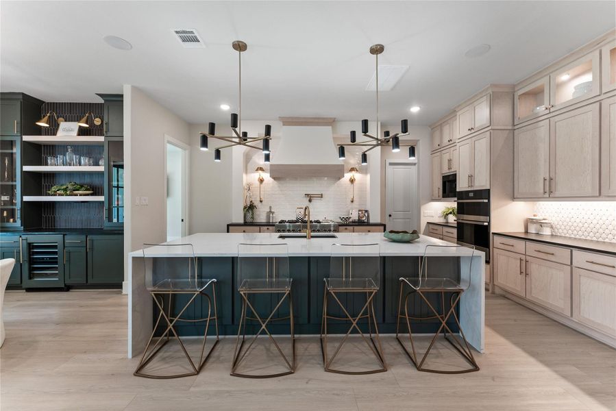 The oversized island offers generous prep, serving, and gathering space for busy mornings or weekend entertaining. Ceiling height cabinetry, soft close storage, and thoughtful pullouts add daily function for a luxury household.