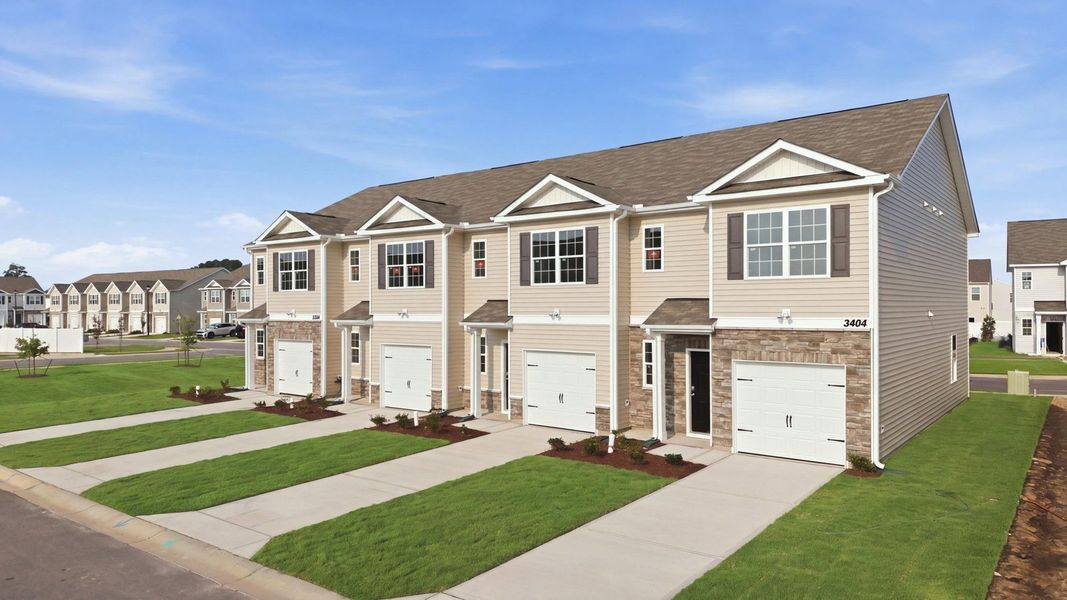 Front exterior of a new home in The Townes at Ridgewood Farms, Winterville, NC, highlighting curb appeal (Image 23). Front exterior of a new home in The Townes at Ridgewood Farms, Winterville, NC, highlighting curb appeal (Image 23).