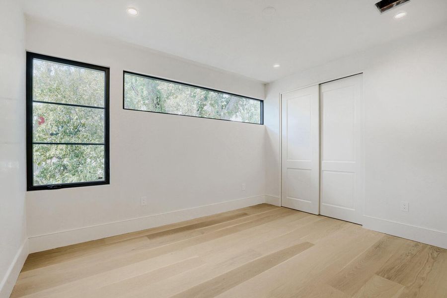 Blonde hardwood flooring complements the naturally illuminated interior of this adaptable space.
