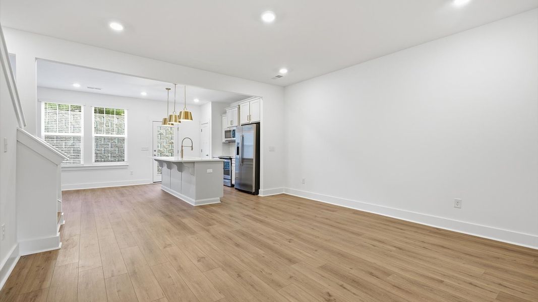 Hardwood flooring and high standards define this vibrant family room ideal for everyday living by DRB Homes