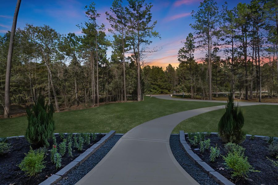 View of the driveway offering ample parking space and a clear look at the home’s well-kept exterior and surrounding landscaping. View of the driveway offering ample parking space and a clear look at the home’s well-kept exterior and surrounding landscaping.