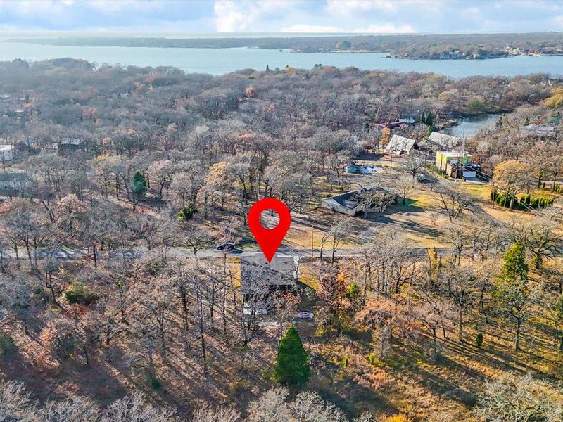 Aerial overview of property's location with a large body of water