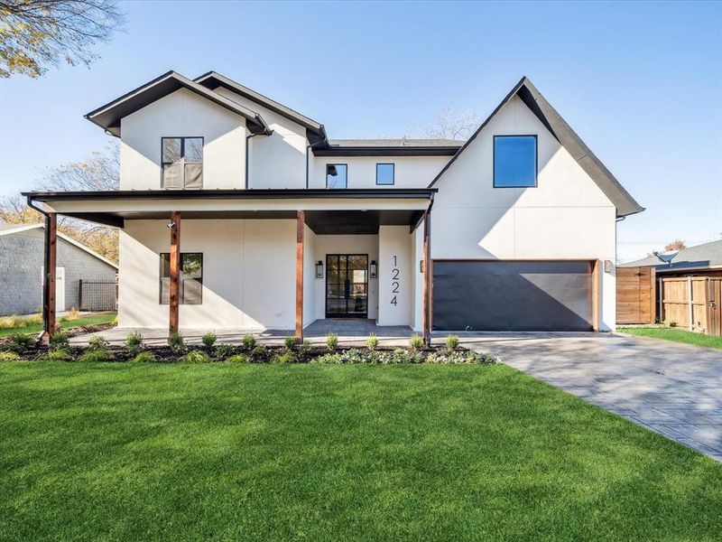 Modern farmhouse style home featuring a porch, a garage, and a front lawn