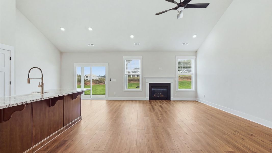 Highly functional family room with established charm and current styling in a reputable community by DRB Homes