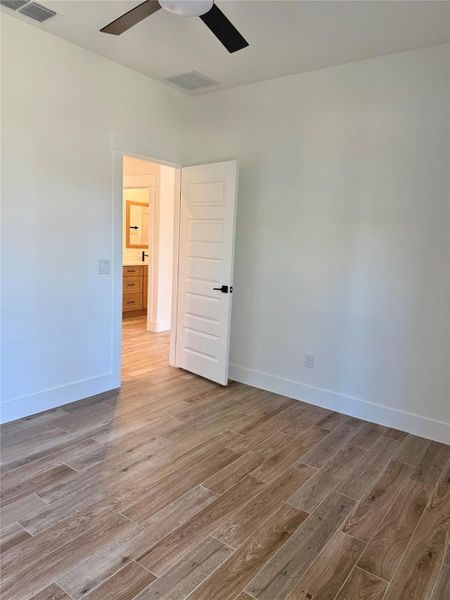 Spare room featuring light wood-style flooring and a ceiling fan