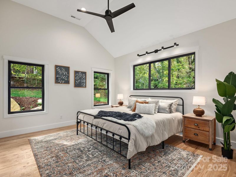 Stunning primary features large windows, airy ceilings, and beautiful finishes