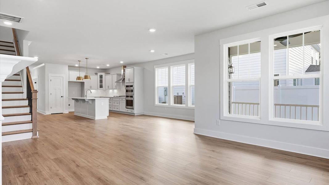 Spacious family room with rich hardwood flooring and elegant trim work in a reputable DRB Homes build