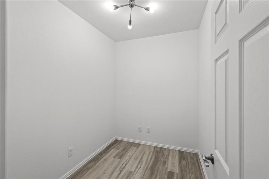 Empty room with wood finished floors and baseboards