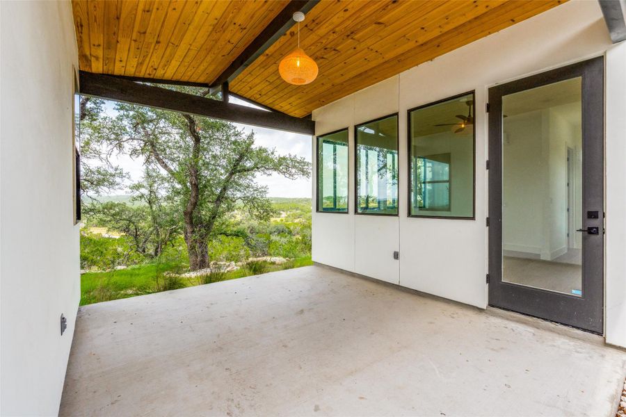 An inviting covered patio with an expansive panoramic view perfect for serene outdoor relaxation.