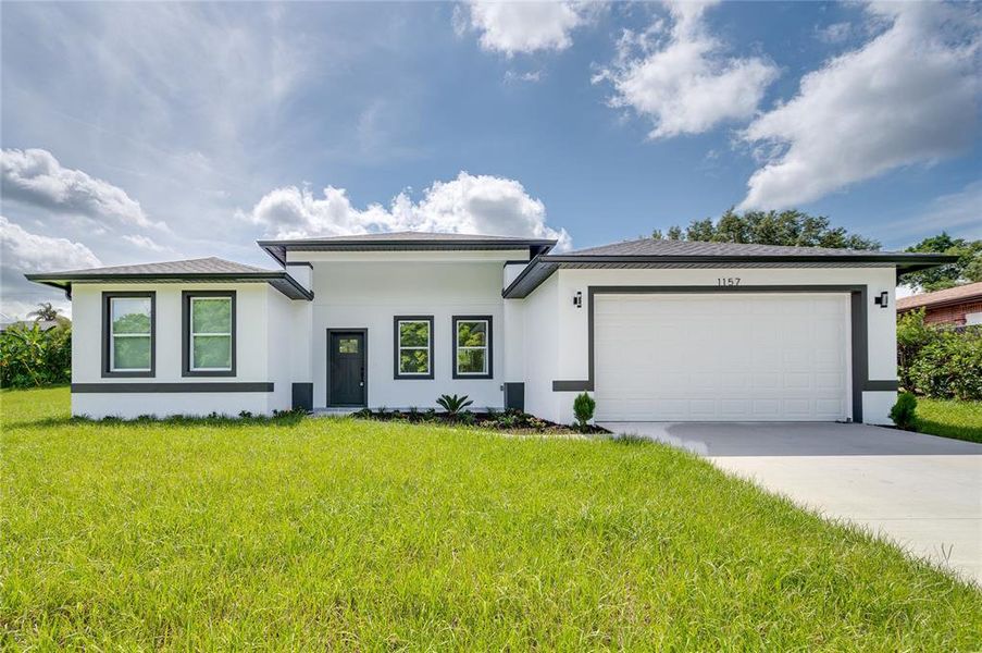 Front exterior of a new home in , Deltona, FL, highlighting curb appeal (Image 1). Front exterior of a new home in , Deltona, FL, highlighting curb appeal (Image 1).
