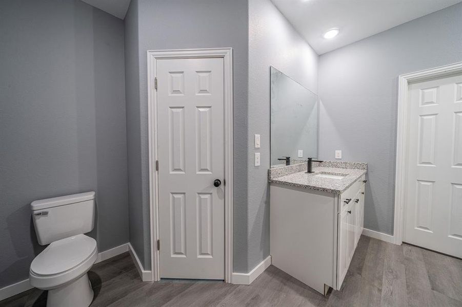 Bathroom with vanity and dark wood-type flooring Bathroom with vanity and dark wood-type flooring