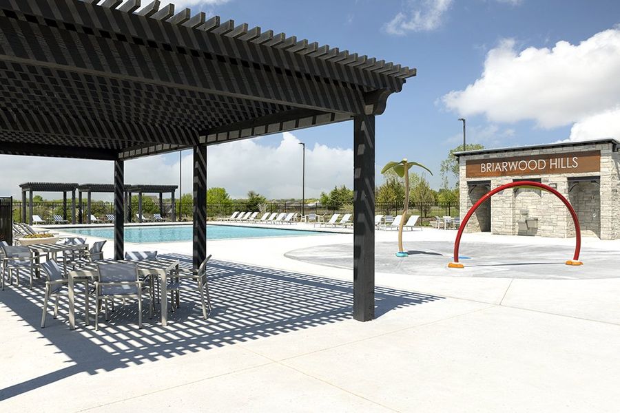 Enjoy the shade while the children play on the kid's splash pad.