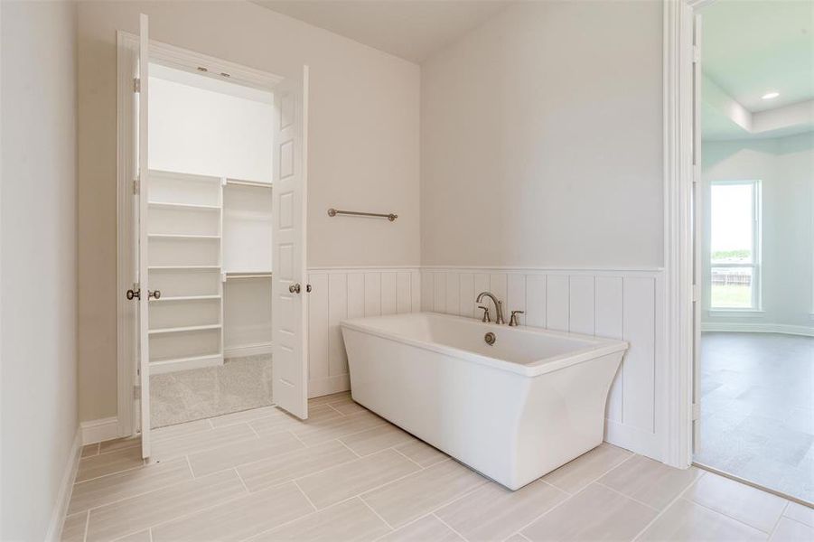 Bathroom featuring a bathing tub and tile patterned floors