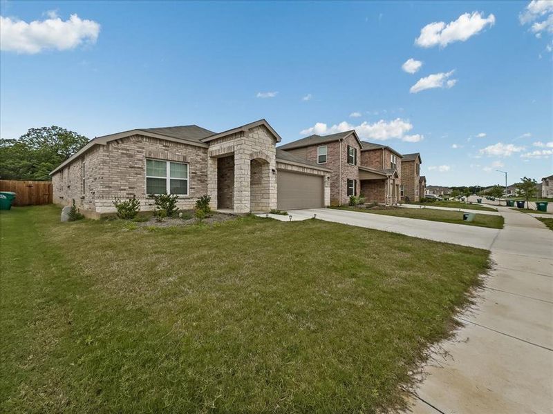 Front exterior of a new home in Townsend Green, Denton, TX, highlighting curb appeal (Image 2).