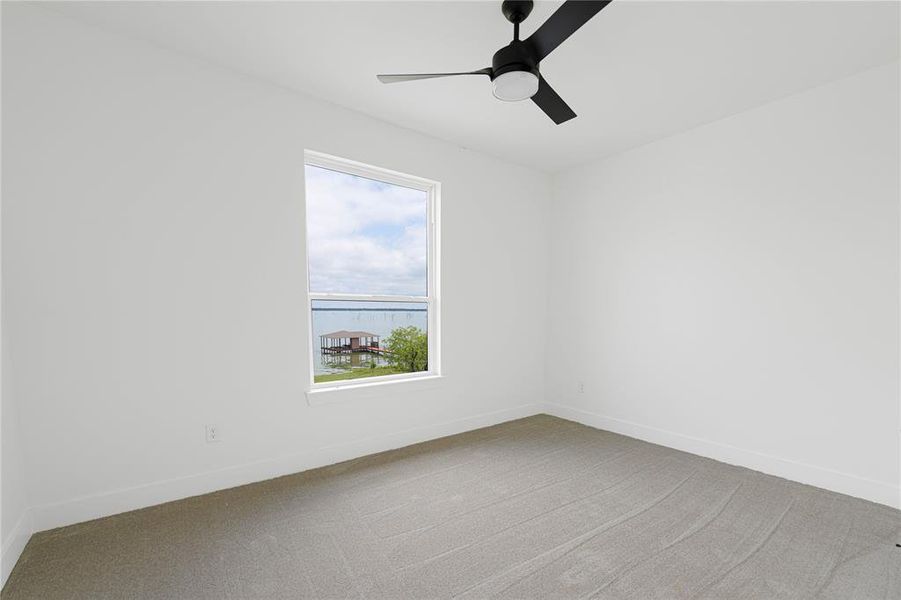Unfurnished room featuring carpet floors and a ceiling fan