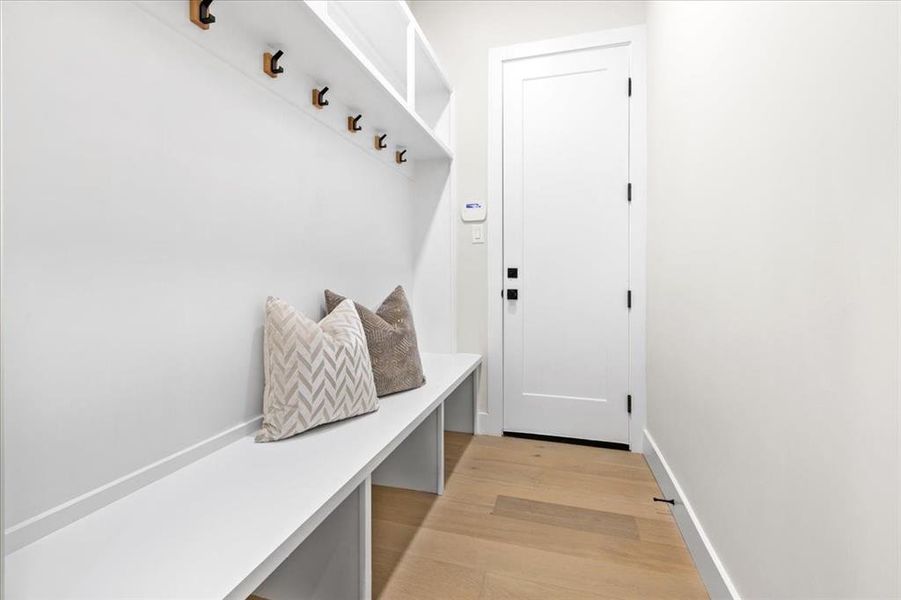 Mudroom with light hardwood / wood-style floors