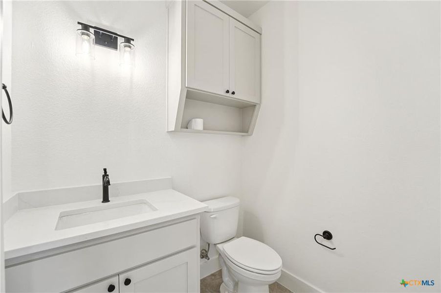 A well-appointed lavatory boasts a modern vanity with integrated sink, offering both style and utility. A well-appointed lavatory boasts a modern vanity with integrated sink, offering both style and utility.