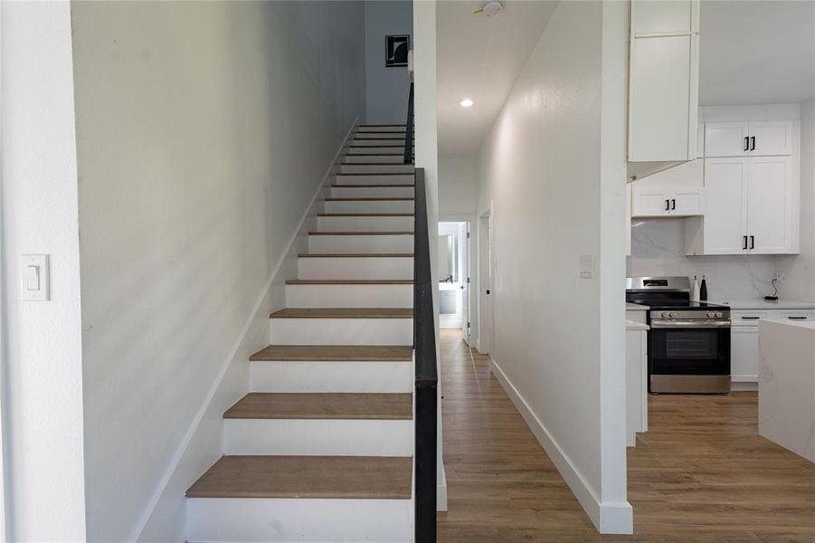 Staircase with wood finished floors and baseboards Staircase with wood finished floors and baseboards