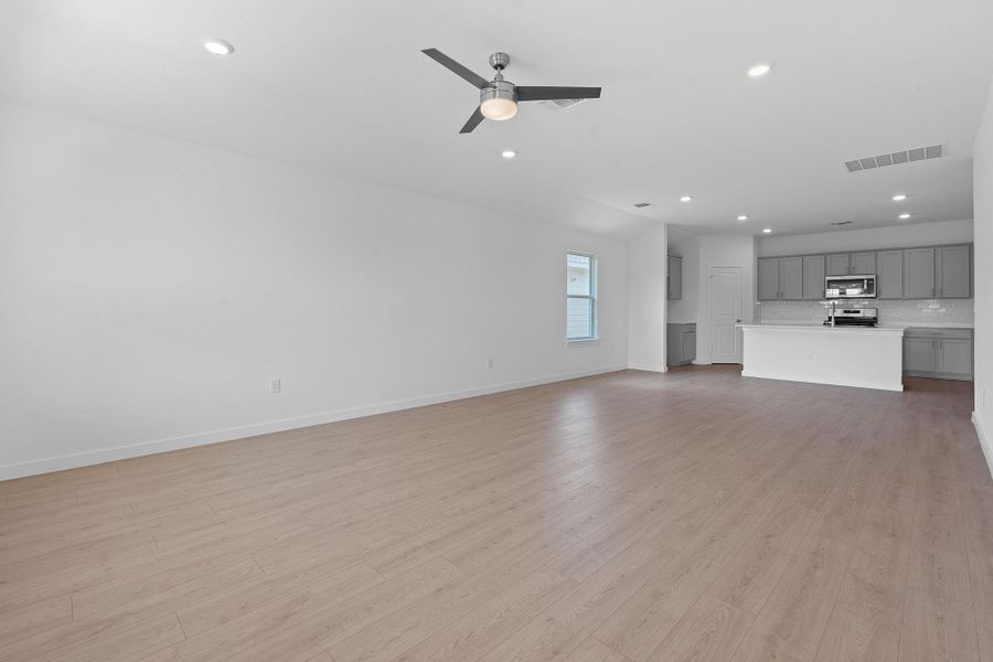 Unfurnished living room with recessed lighting, light wood-style flooring, and ceiling fan Unfurnished living room with recessed lighting, light wood-style flooring, and ceiling fan