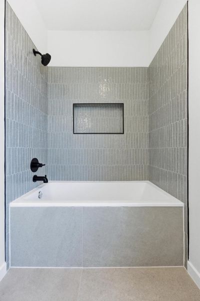 Bathroom with tub / shower combination and tile patterned floors