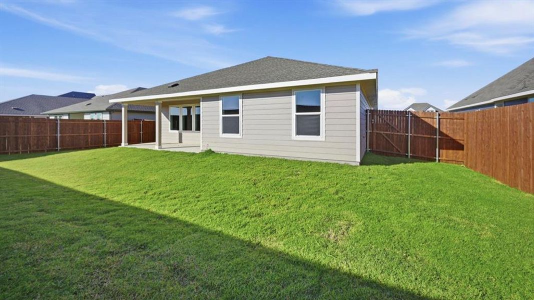 Rear view of property with a patio, roof with shingles, and a fenced backyard Rear view of property with a patio, roof with shingles, and a fenced backyard