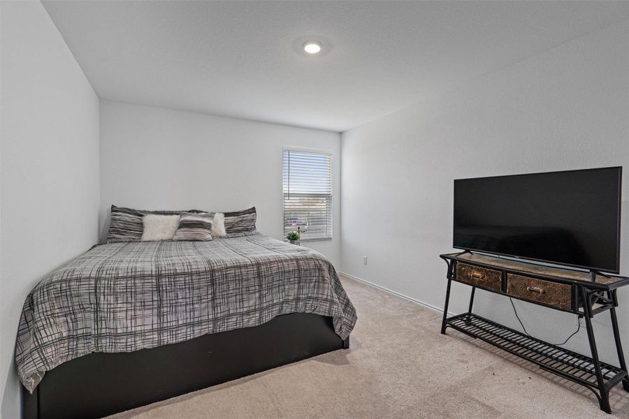 Bedroom with carpet flooring and baseboards