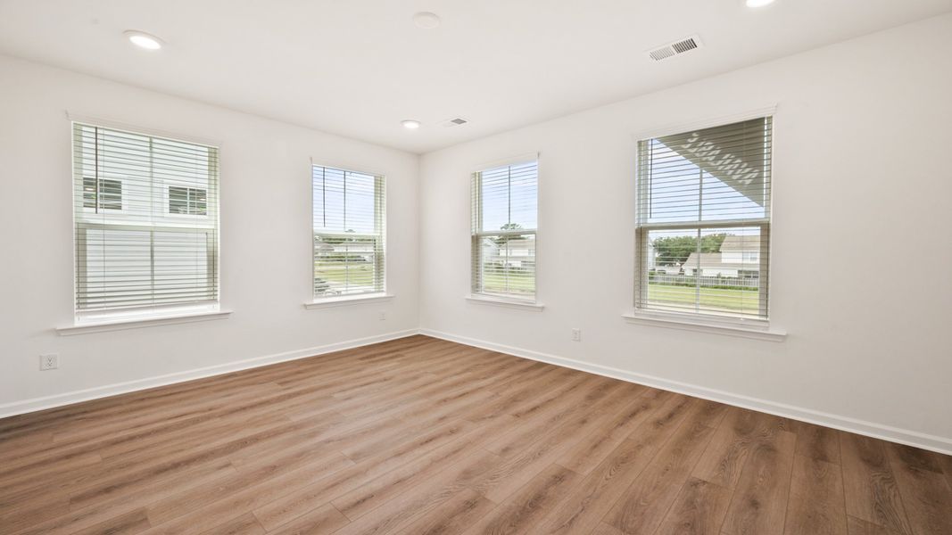 Living Room with LVP flooring in Hayden Floorplan at Clear Springs Townhomes