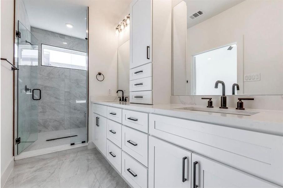 Bathroom with an enclosed shower and vanity